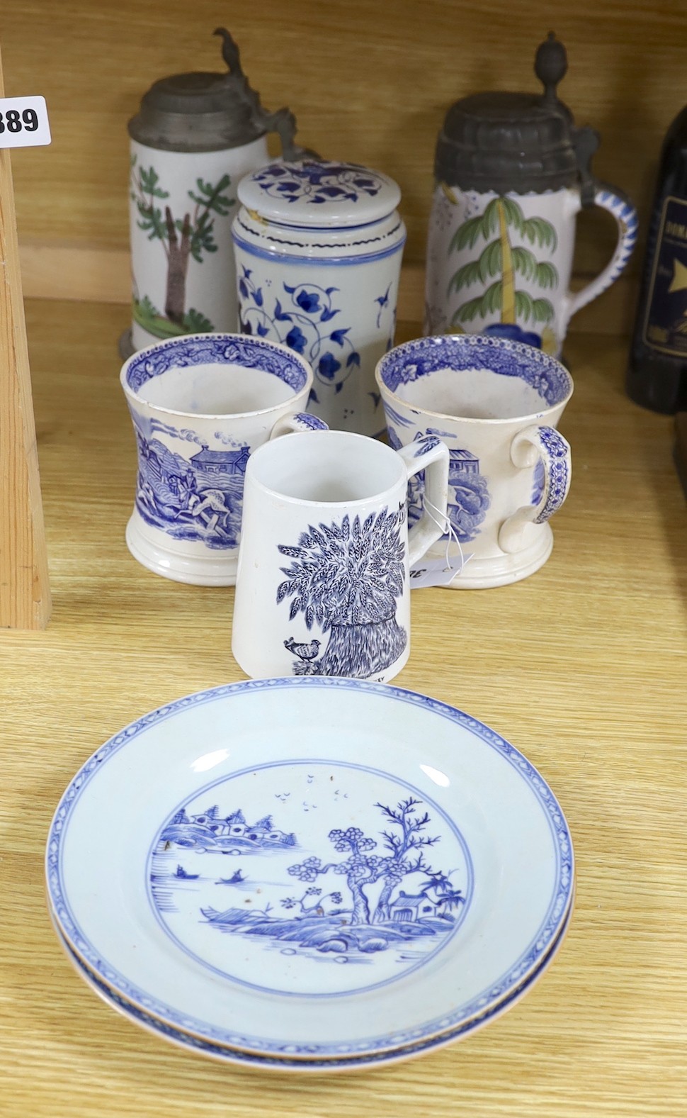 A pair of German 17th century faience pewter mounted steins, together with a selection of blue and white ceramics, tallest 26cm